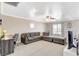 Carpeted loft with comfortable seating area, ceiling fan, and natural lighting, perfect for relaxation and entertainment at 5516 Tantalum Ln, Las Vegas, NV 89122