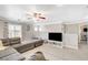 This carpeted loft features a comfortable seating area with large screen TV, a ceiling fan and a wall of natural light at 5516 Tantalum Ln, Las Vegas, NV 89122