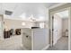 This cozy carpeted loft features a ceiling fan, a desk area, and a comfortable sitting area, perfect for relaxation at 5516 Tantalum Ln, Las Vegas, NV 89122