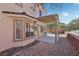 View of the backyard with covered patio, landscaping and block wall at 575 Aspen Leaf St, Las Vegas, NV 89144