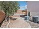 View of the backyard and covered patio with landscaping and block wall at 575 Aspen Leaf St, Las Vegas, NV 89144