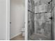 Modern bathroom with gray tile shower and a separate toilet room at 575 Aspen Leaf St, Las Vegas, NV 89144