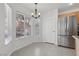 A cozy breakfast nook boasts natural light and a stainless steel refrigerator at 575 Aspen Leaf St, Las Vegas, NV 89144
