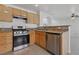 This kitchen features stainless steel appliances, granite counters, and wood cabinets at 575 Aspen Leaf St, Las Vegas, NV 89144