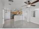 Open-concept living space with tile flooring, modern ceiling fan, and bright kitchen at 575 Aspen Leaf St, Las Vegas, NV 89144