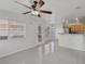 Open-concept living space with tile flooring, modern ceiling fan, and bright kitchen at 575 Aspen Leaf St, Las Vegas, NV 89144