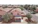 Aerial view of a two-story home, showing the backyard with a covered patio in a neighborhood with other homes at 575 Aspen Leaf St, Las Vegas, NV 89144