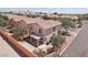 Aerial view of a two-story home, showing the backyard with a covered patio in a neighborhood with other homes at 575 Aspen Leaf St, Las Vegas, NV 89144
