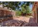 Scenic backyard with stone patio, garden beds, and mature trees at 5896 Shining Moon Ct, Las Vegas, NV 89131