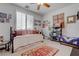 Inviting bedroom with a daybed, area rug, and lots of pictures on the wall at 5896 Shining Moon Ct, Las Vegas, NV 89131