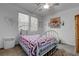 Bright bedroom featuring a decorative metal-frame bed, natural light, and a serene atmosphere for relaxation at 5896 Shining Moon Ct, Las Vegas, NV 89131