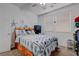 Comfortable bedroom with two windows, marine decor, and a ceiling fan at 5896 Shining Moon Ct, Las Vegas, NV 89131