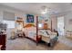 Bright bedroom with a four post bed, ceiling fan and door to the backyard at 5896 Shining Moon Ct, Las Vegas, NV 89131