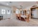 Dining room with bright entrance doors and seating for six, plus an elegant cabinet at 5896 Shining Moon Ct, Las Vegas, NV 89131