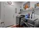 Modern laundry room with shelving and side by side washer and dryer at 5896 Shining Moon Ct, Las Vegas, NV 89131