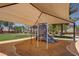 Community playground with slides and climbing structures under a shaded canopy at 5896 Shining Moon Ct, Las Vegas, NV 89131
