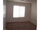 Bright bedroom featuring neutral carpet, a window, and ample natural light at 59 Belle Maison Ave, Las Vegas, NV 89123
