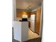 Compact kitchen features wood cabinetry, a microwave, and white appliances at 59 Belle Maison Ave, Las Vegas, NV 89123