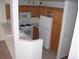Functional kitchen featuring white appliances, natural wood cabinets, and a breakfast bar at 59 Belle Maison Ave, Las Vegas, NV 89123