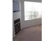 Cozy living room featuring a fireplace, neutral carpet, and a bright window at 59 Belle Maison Ave, Las Vegas, NV 89123