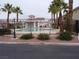 Community pool surrounded by a black metal fence and mature palm trees at 59 Belle Maison Ave, Las Vegas, NV 89123