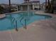 A community pool with a jacuzzi, covered seating, and access ladder at 59 Belle Maison Ave, Las Vegas, NV 89123