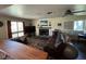 Spacious living room featuring a fireplace, large windows, and comfortable seating at 632 Tam O Shanter, Las Vegas, NV 89109