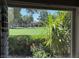 Scenic view from a window overlooking a lush green lawn and mature trees at 632 Tam O Shanter, Las Vegas, NV 89109