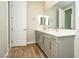 Bright bathroom featuring double vanity, quartz countertops and modern fixtures at 7199 Twilight Rider Ct, Las Vegas, NV 89118