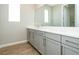 Bright bathroom featuring double vanity, quartz countertops and modern fixtures at 7199 Twilight Rider Ct, Las Vegas, NV 89118