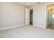 Bedroom with plush carpet and view of en-suite bathroom with glass-enclosed shower at 7199 Twilight Rider Ct, Las Vegas, NV 89118