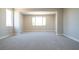 Bright bonus room featuring neutral carpet, large windows, and neutral paint at 7199 Twilight Rider Ct, Las Vegas, NV 89118