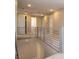 Hallway with gray railings overlooking the staircase and a view of several doorways at 7199 Twilight Rider Ct, Las Vegas, NV 89118