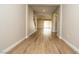Hallway with wood-look tile flooring and open access to the living spaces of the home at 7199 Twilight Rider Ct, Las Vegas, NV 89118