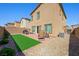 Well-maintained backyard featuring a patio, artificial grass, and a built-in grill for outdoor gatherings at 7730 Moore Creek Ln, North Las Vegas, NV 89084