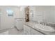 Elegant bathroom with double sinks, granite counters, and a walk-in closet at 7730 Moore Creek Ln, North Las Vegas, NV 89084