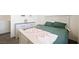 Neutral bedroom features a beautiful dresser and bed at 7730 Moore Creek Ln, North Las Vegas, NV 89084