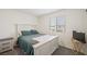 Clean and bright bedroom with neutral tones, a large window and matching furnishings at 7730 Moore Creek Ln, North Las Vegas, NV 89084
