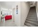 Inviting hallway with carpeted stairs and natural light, connecting the living spaces and upper floors at 7730 Moore Creek Ln, North Las Vegas, NV 89084