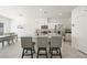 Modern kitchen featuring a spacious island with seating, stainless steel appliances, and an adjacent dining area under recessed lighting at 7730 Moore Creek Ln, North Las Vegas, NV 89084
