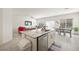 Bright kitchen with stainless steel appliances, granite countertops, and an island overlooking the dining and living areas at 7730 Moore Creek Ln, North Las Vegas, NV 89084