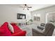 Inviting living room features a large screen tv and comfortable seating, complemented by bright light from the windows at 7730 Moore Creek Ln, North Las Vegas, NV 89084