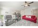 Bright, open living space featuring tile floors, modern furnishings, and seamless transition to the kitchen and dining area at 7730 Moore Creek Ln, North Las Vegas, NV 89084