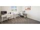 Bright office space with multiple work areas and natural light at 7730 Moore Creek Ln, North Las Vegas, NV 89084