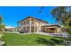 Large backyard showcasing lush grass, a pool, an outdoor kitchen, and a cabana bar at 8010 Palm Cove Ct, Las Vegas, NV 89129