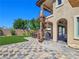 Paver patio with spiral staircase, built in BBQ area and synthetic lawn at 8010 Palm Cove Ct, Las Vegas, NV 89129