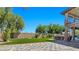 Spacious backyard with a paved patio, spiral staircase, and an outdoor kitchen area at 8010 Palm Cove Ct, Las Vegas, NV 89129