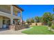 Beautiful backyard featuring a built-in barbecue, lush lawn, and outdoor seating area at 8010 Palm Cove Ct, Las Vegas, NV 89129