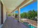 Covered balcony with views of the backyard, hot tub, and mature trees at 8010 Palm Cove Ct, Las Vegas, NV 89129