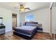 Modern bedroom with hardwood floors, closet, and a large window at 8010 Palm Cove Ct, Las Vegas, NV 89129